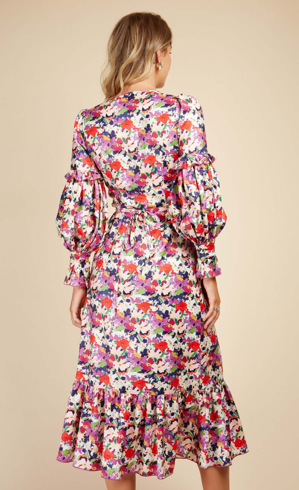 Floral Satin Wrap Dress with Peplum Hem on model, showcasing vibrant colors and puffed sleeves.