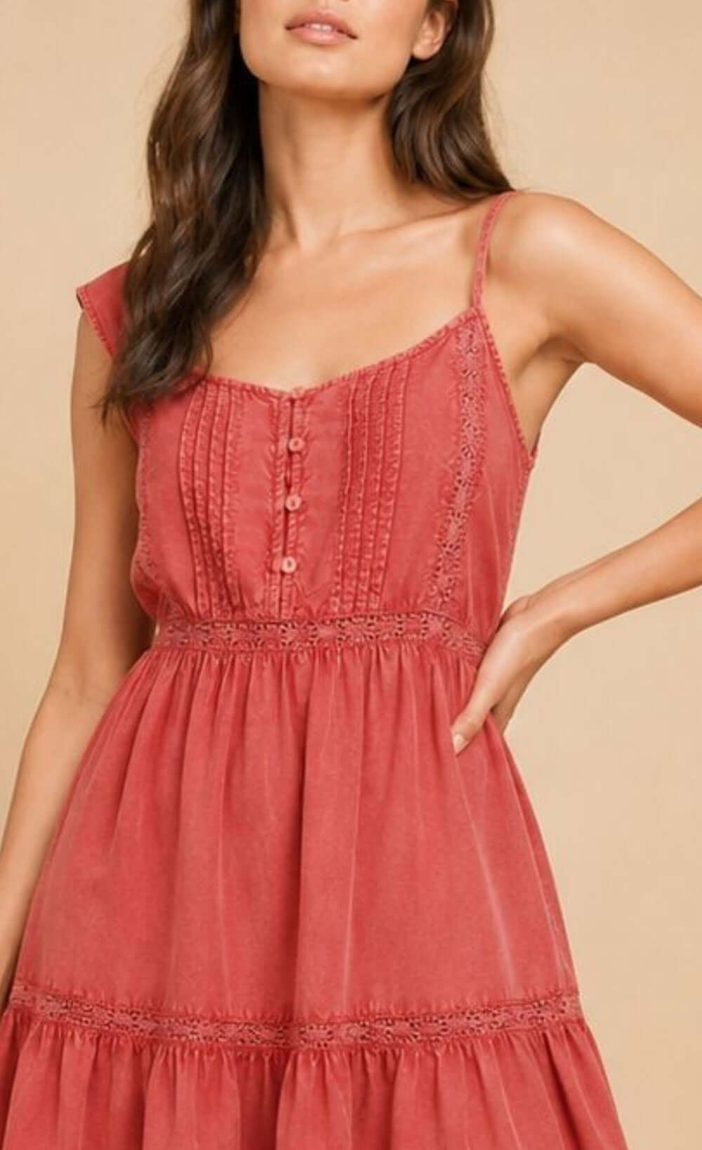 Pink ruffle mini dress featuring spaghetti straps, button-front detail, and playful ruffle hem.