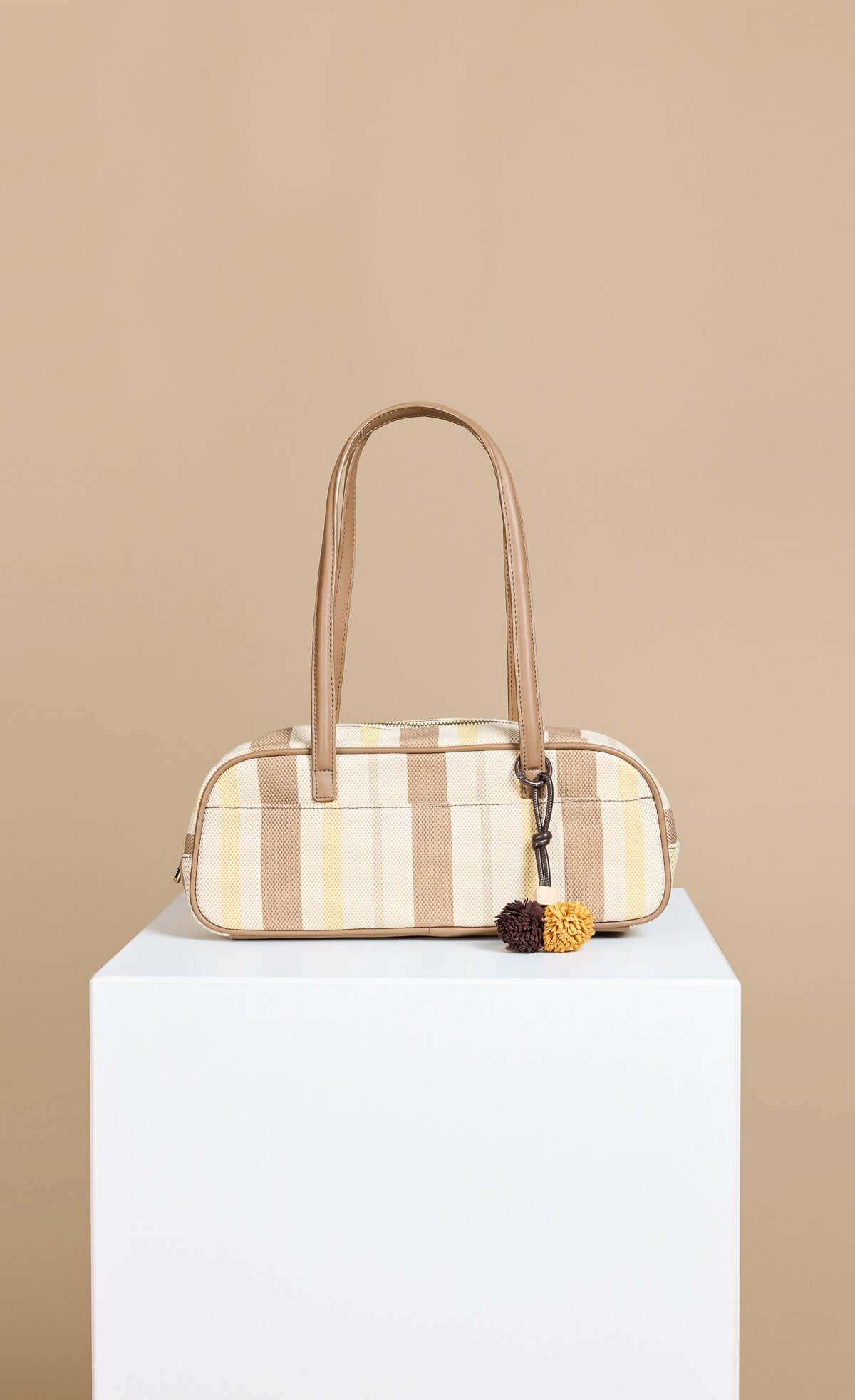 Mocha Lemon Stripe Elongated Shoulder Bag with faux leather straps and pom pom charm detail