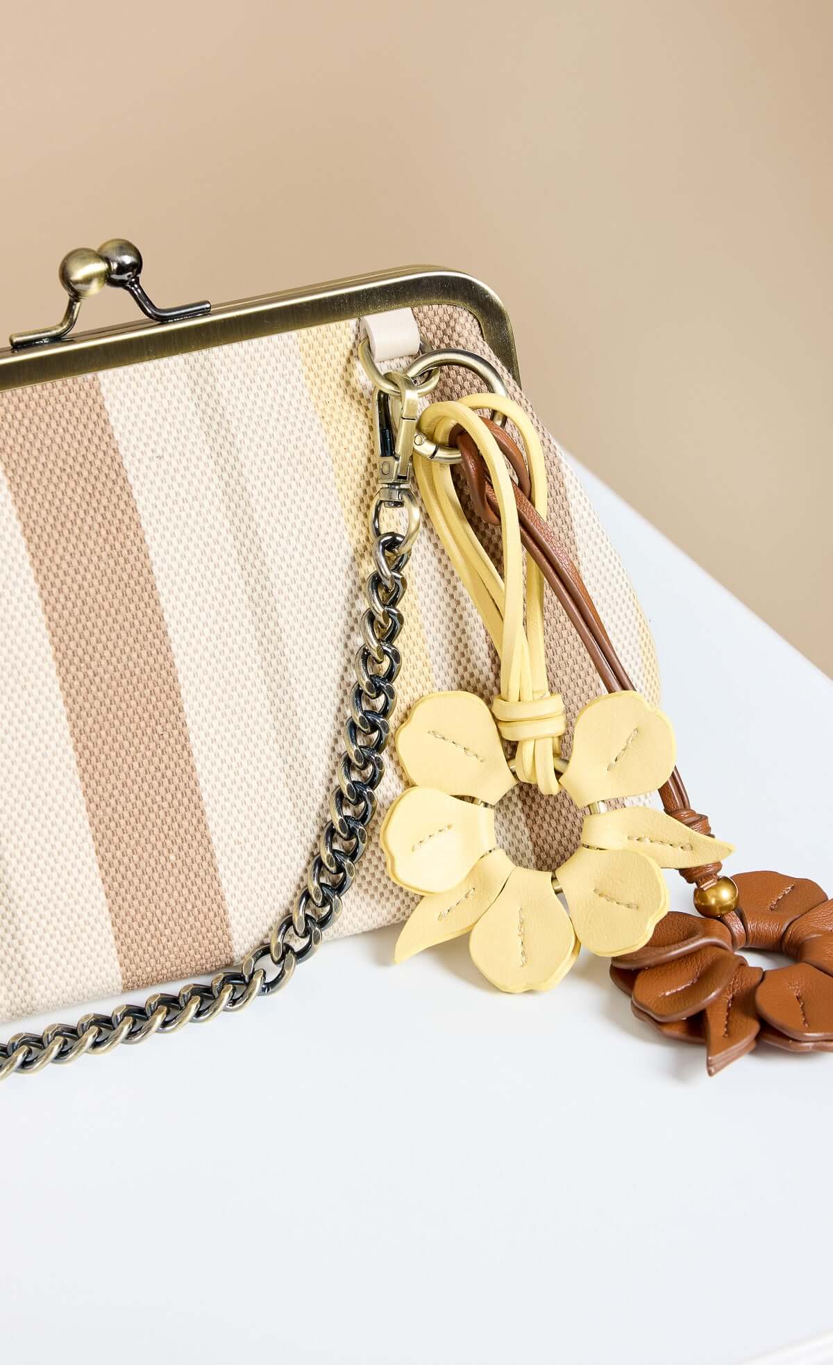 Mocha Lemon Stripe Metal Frame Shoulder Bag with chain strap and flower charm detail.