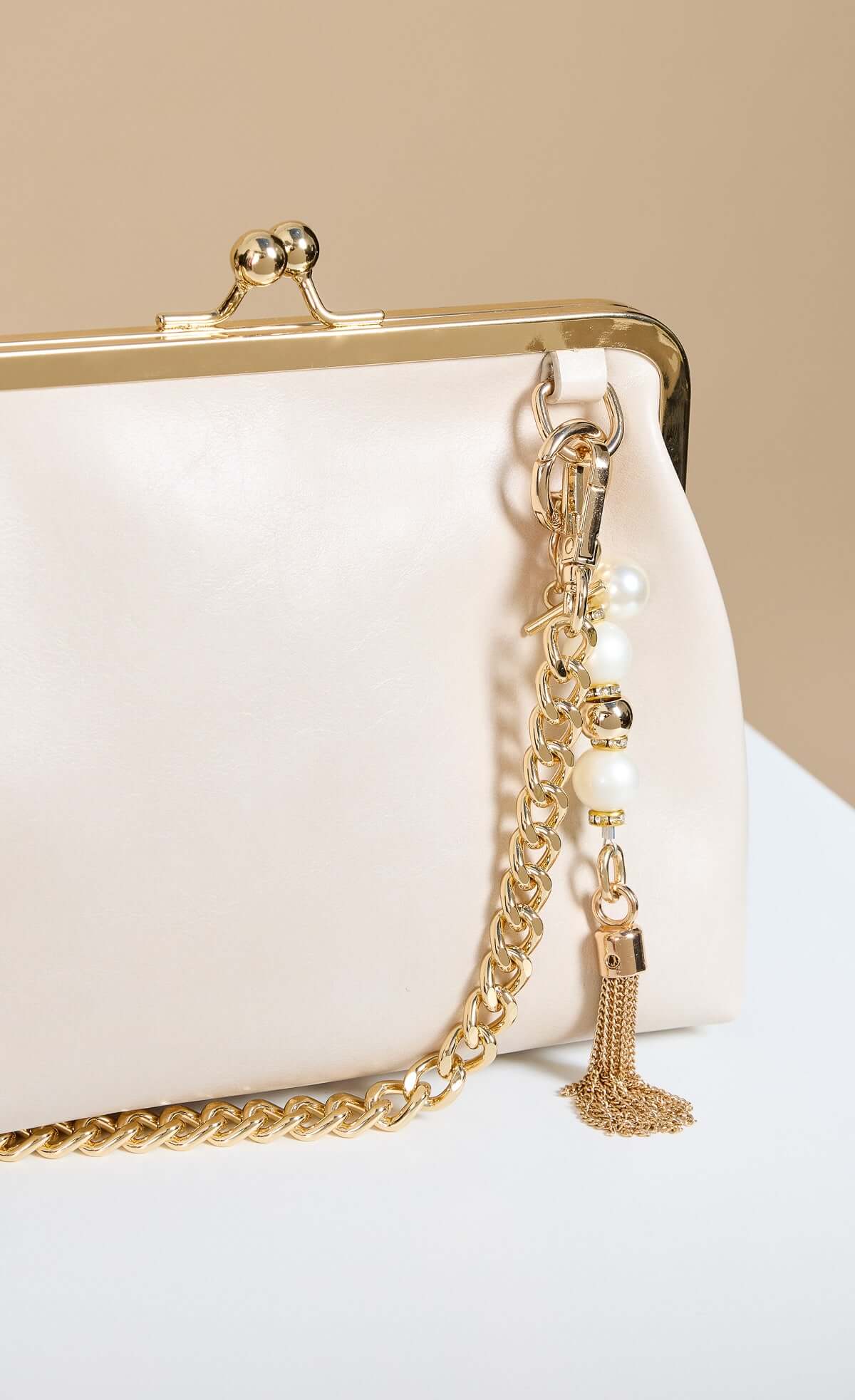 Ecru Faux Leather Metal Frame Shoulder Bag with chain strap and pearl charm with gold metal finish.