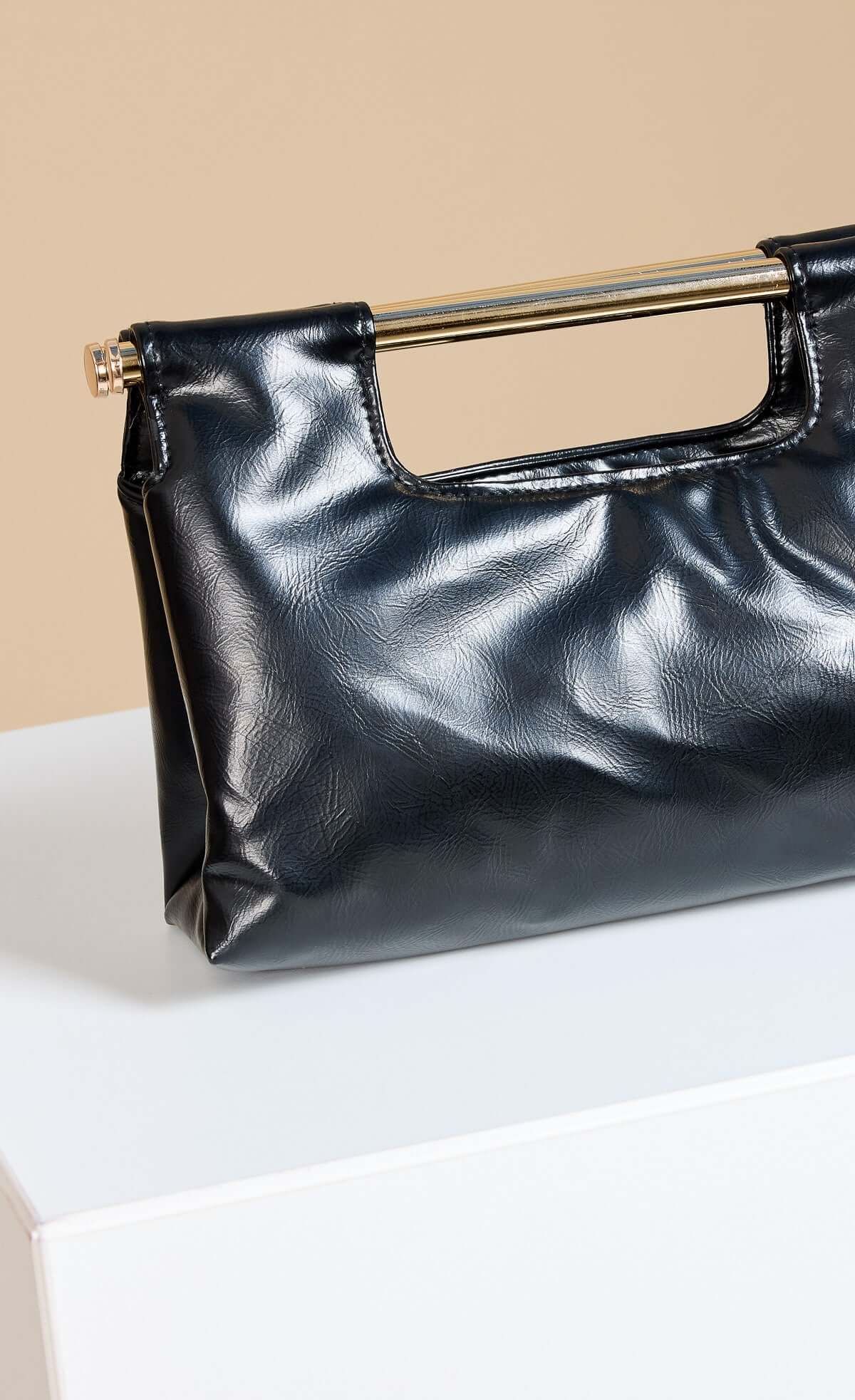 Black Metal Bar Clutch Bag in soft faux leather with a gold handle detail