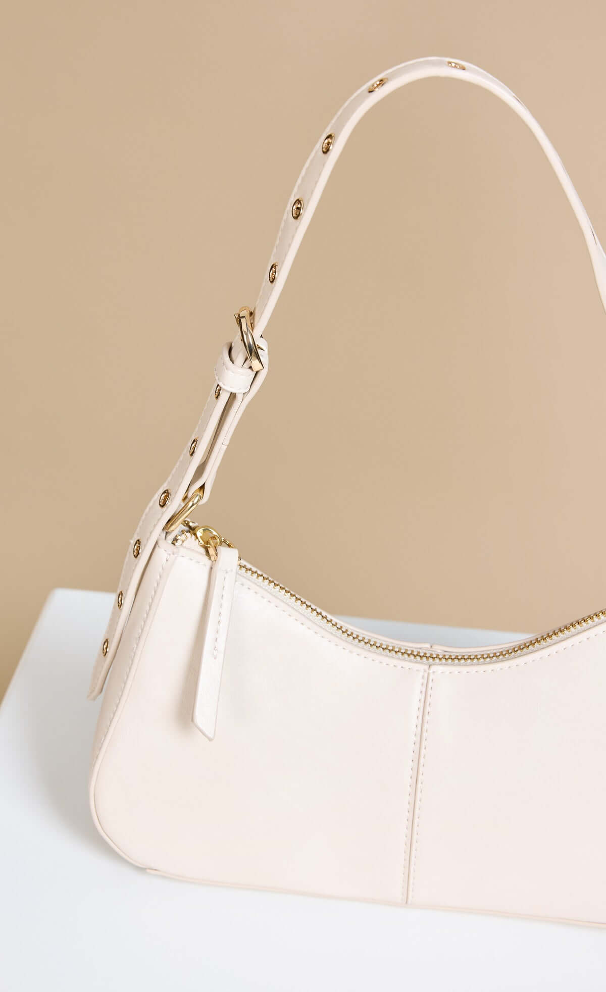 Stone Curved Top Shoulder Bag with adjustable strap and zipper detail in faux leather.