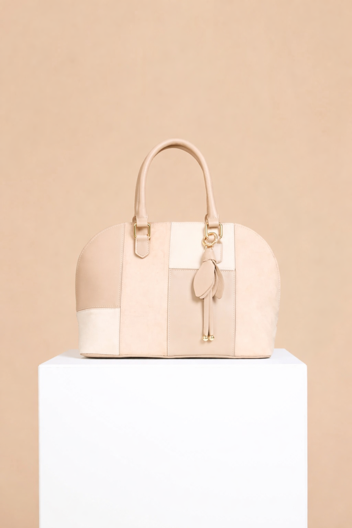 Beige Faux Leather & Suede Patchwork Midi Tote with gold metal trims and flower charm on display.