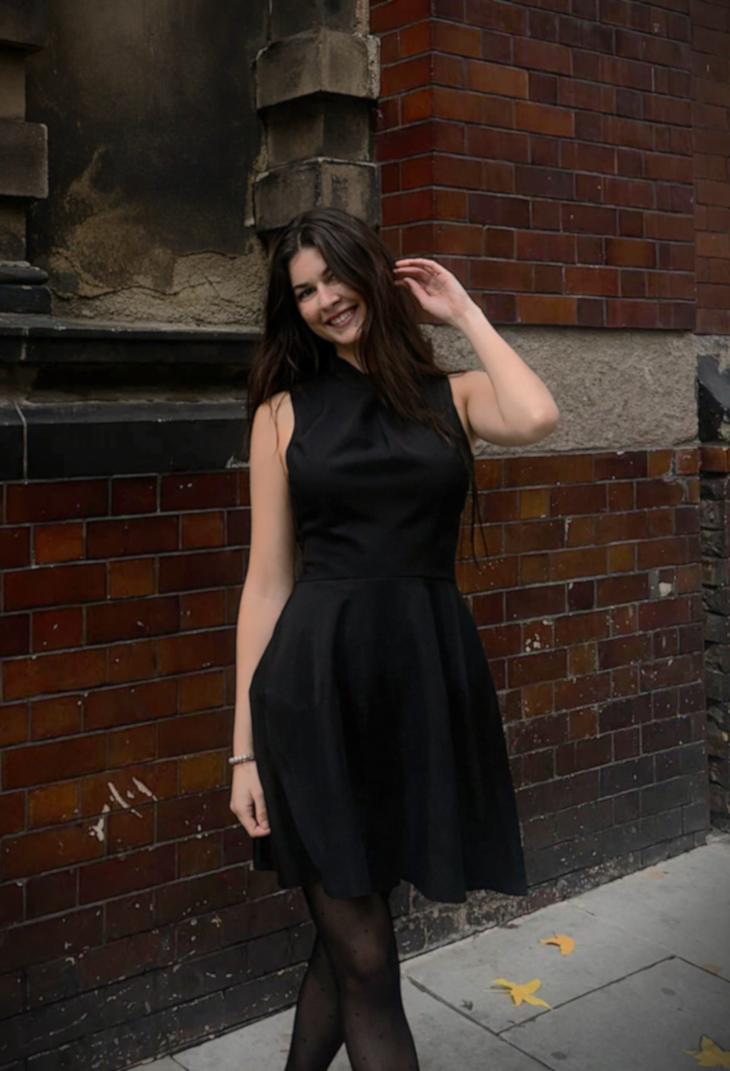 Black Twist Neck Mini Dress worn by a model, featuring a chic twist-neck and flared mini skirt.