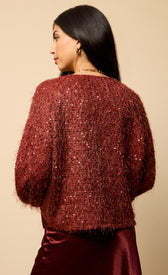 Mireille Cherry Sequin Eyelash Jumper featuring a cozy red design with sparkling sequins and textured fabric.