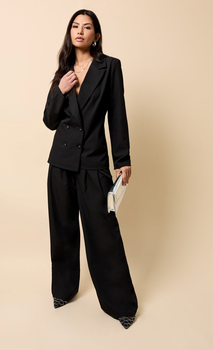 Noelle Black Trousers paired with a sleek black blazer for a polished and modern look.