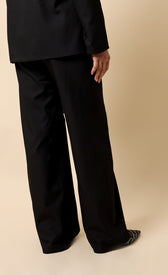 Noelle Black Trousers shown from behind, featuring a high waist and wide leg design for a modern tailored look.