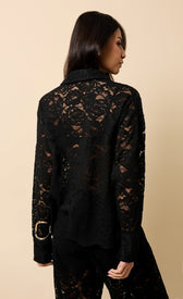 Micaela Black Lace Shirt showcasing a woman from the back, featuring an elegant lace design and turn-down collar.