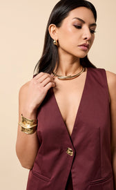 Odette Cherry Accent Button Waistcoat on model showcasing V-neck and sleeveless design with gold jewelry.