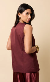 Image of a model showcasing the Odette Cherry Accent Button Waistcoat, featuring a sleeveless design and V-neck.