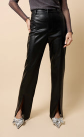 Natasia Black PU Split Detail Wide Leg Trousers showcased with stylish silver footwear, emphasizing modern elegance.