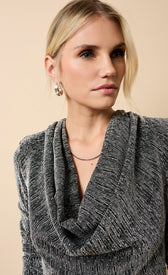 Woman wearing the Sylvie Black and Silver Cowl Neck Midaxi Dress with a stylish gray cowl neck and silver earrings.