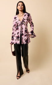 Naelle Multi Floral Print Tie Detail Top worn with black pants, featuring long sleeves and a flattering V-neckline.