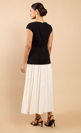 Amoura Monochrome Dropped Waist Maxi Dress worn from the back, featuring short sleeves and a high neck.