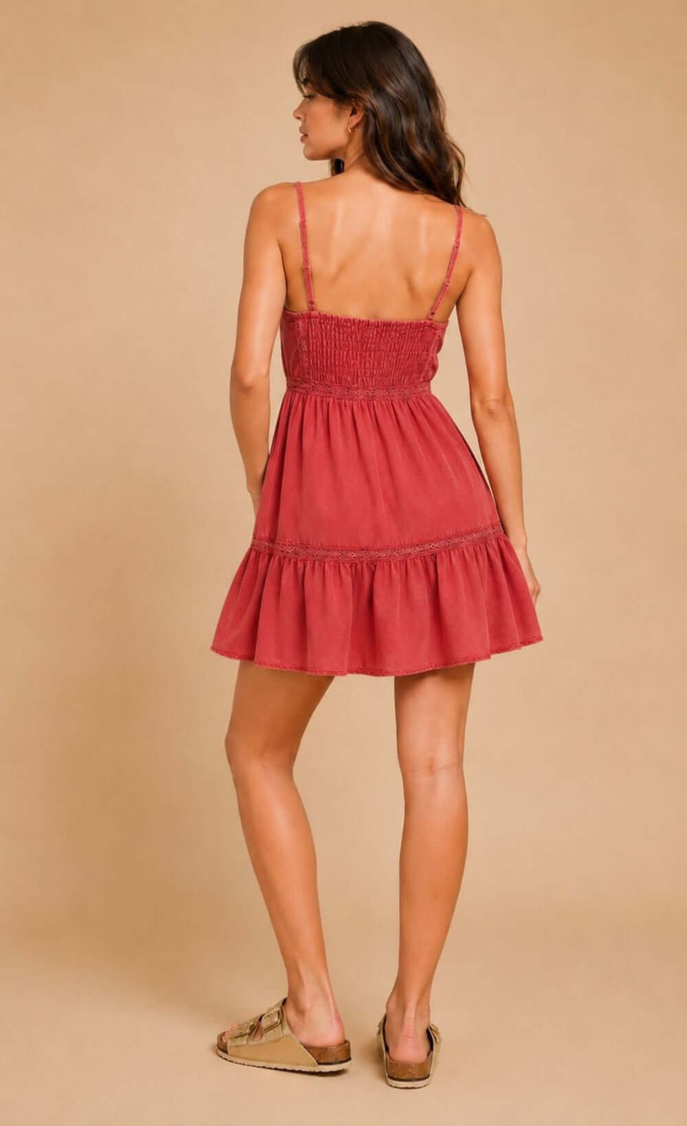 Trendy UK woman showcasing a pink ruffle mini dress with spaghetti straps and playful ruffle hem, Ref. D36105C1A.