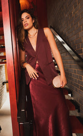 Model wearing Odette Cherry Accent Button Waistcoat with burgundy skirt, showcasing a chic layered look.